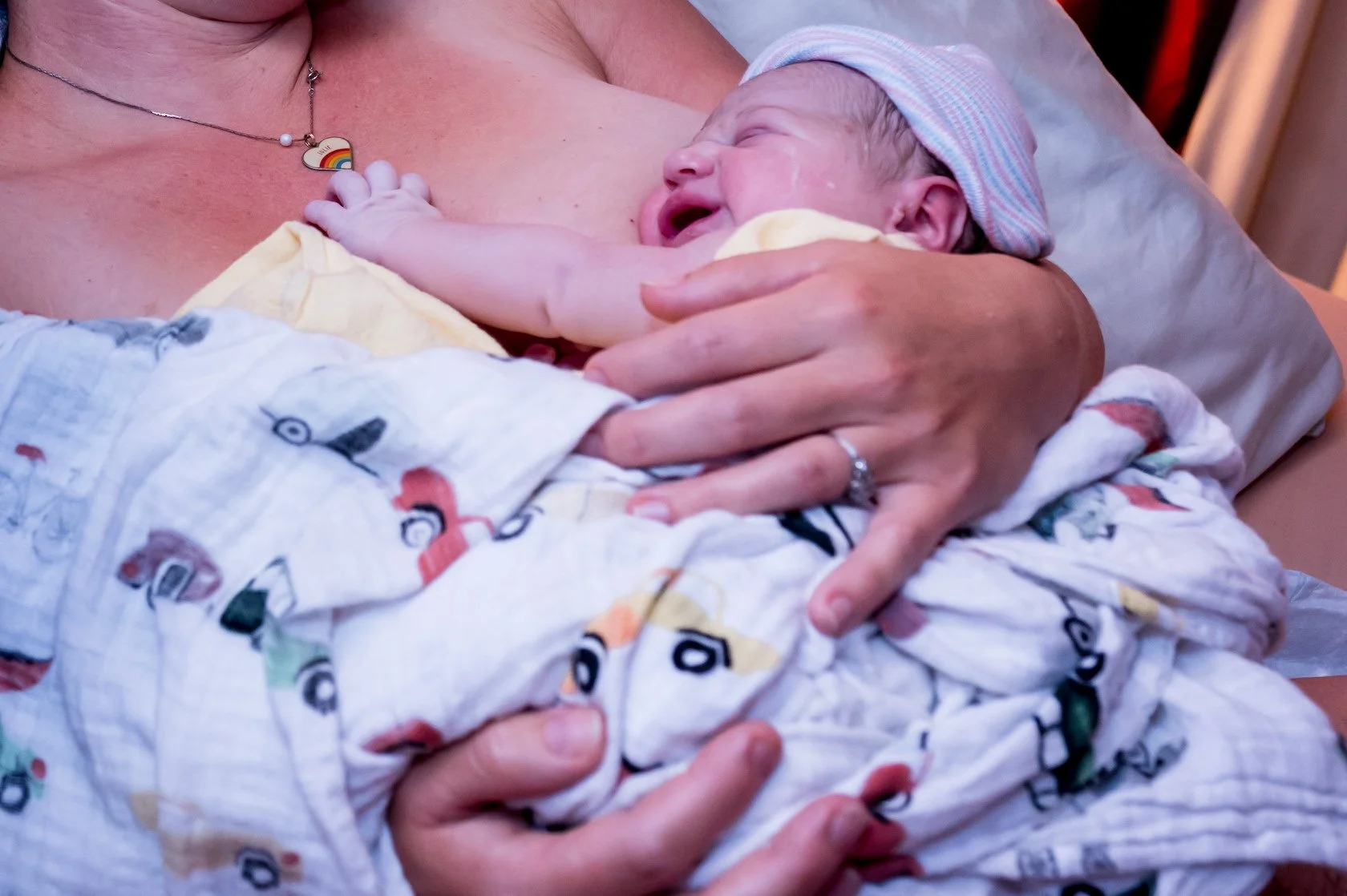 A queer mother who has received home IUI and midwifery care from Bay Fertility Care holds her newborn after giving birth at home. Photo Credit: El Tarver LM, CPM - Midwife in Berkeley, CA