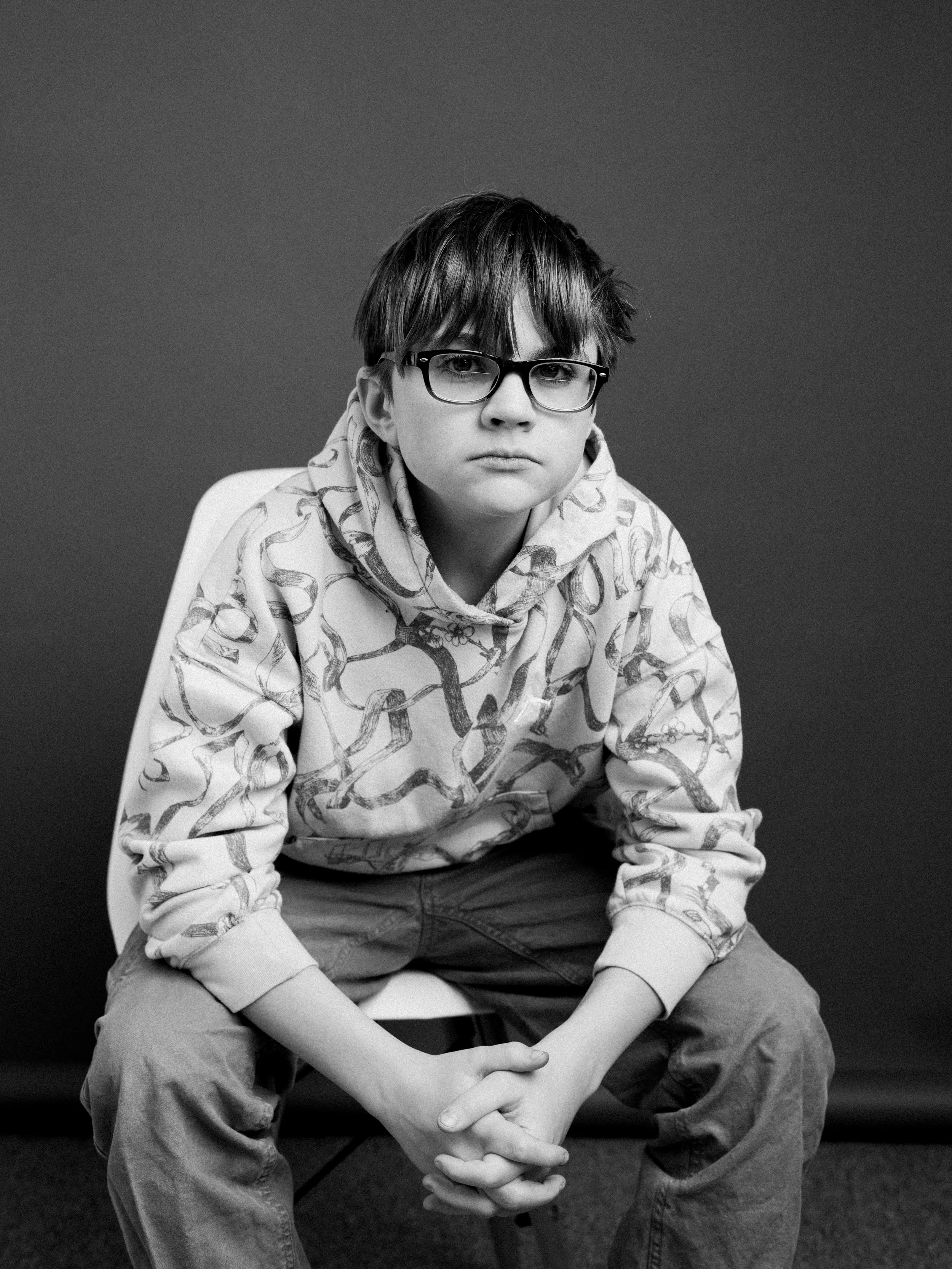 Teen boy with a thoughtful expression during an unposed studio portrait session