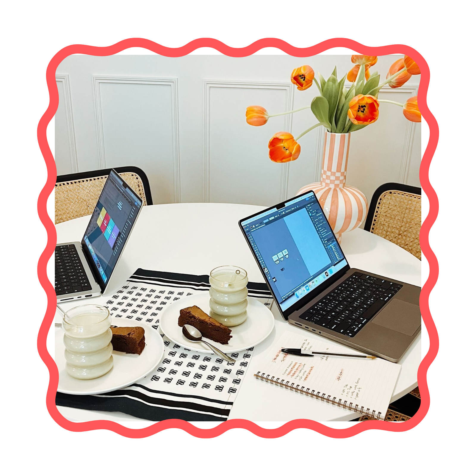 Desk of computers with matcha and cake