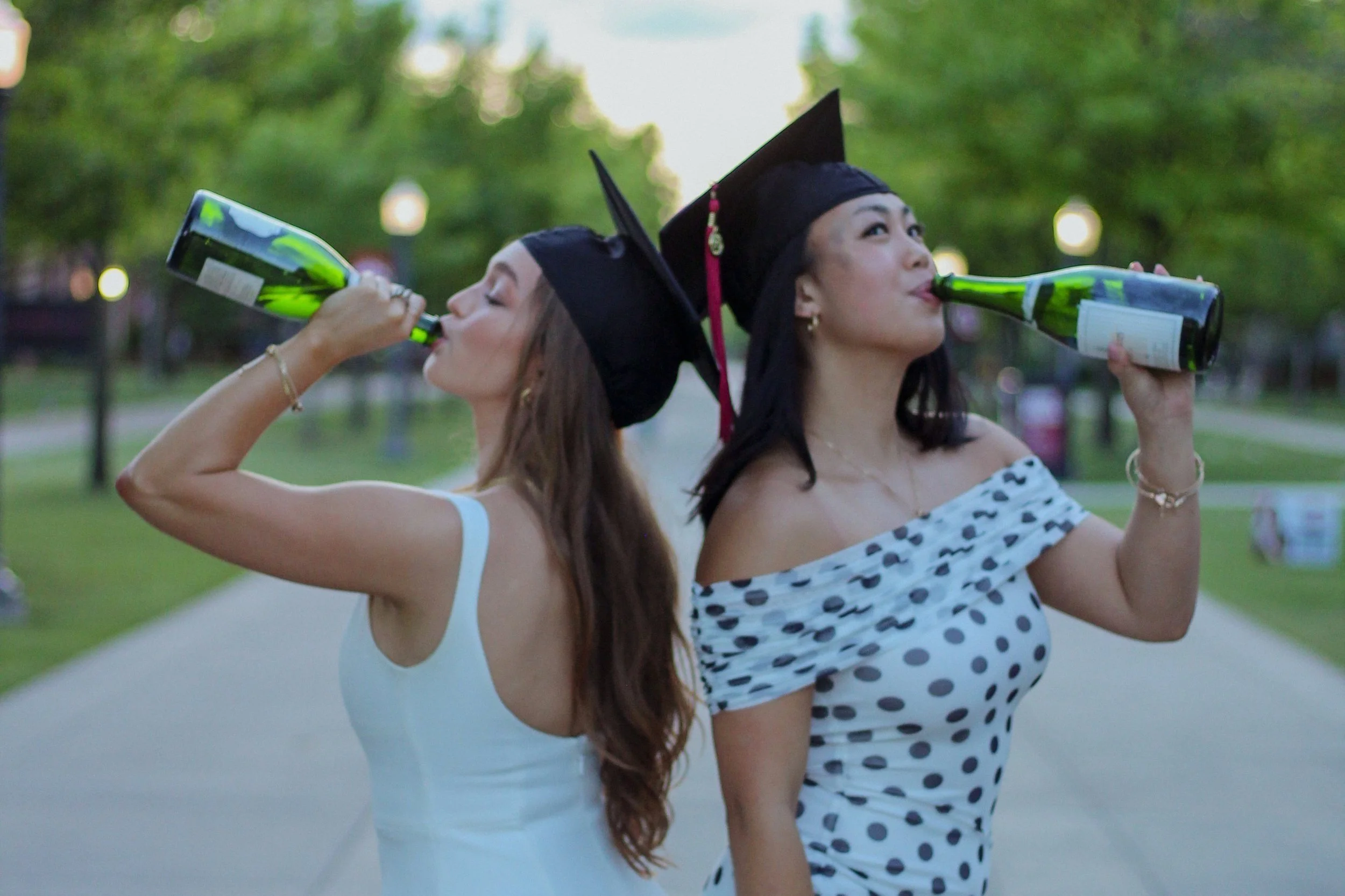 two female OU College grads drinking Champagne 