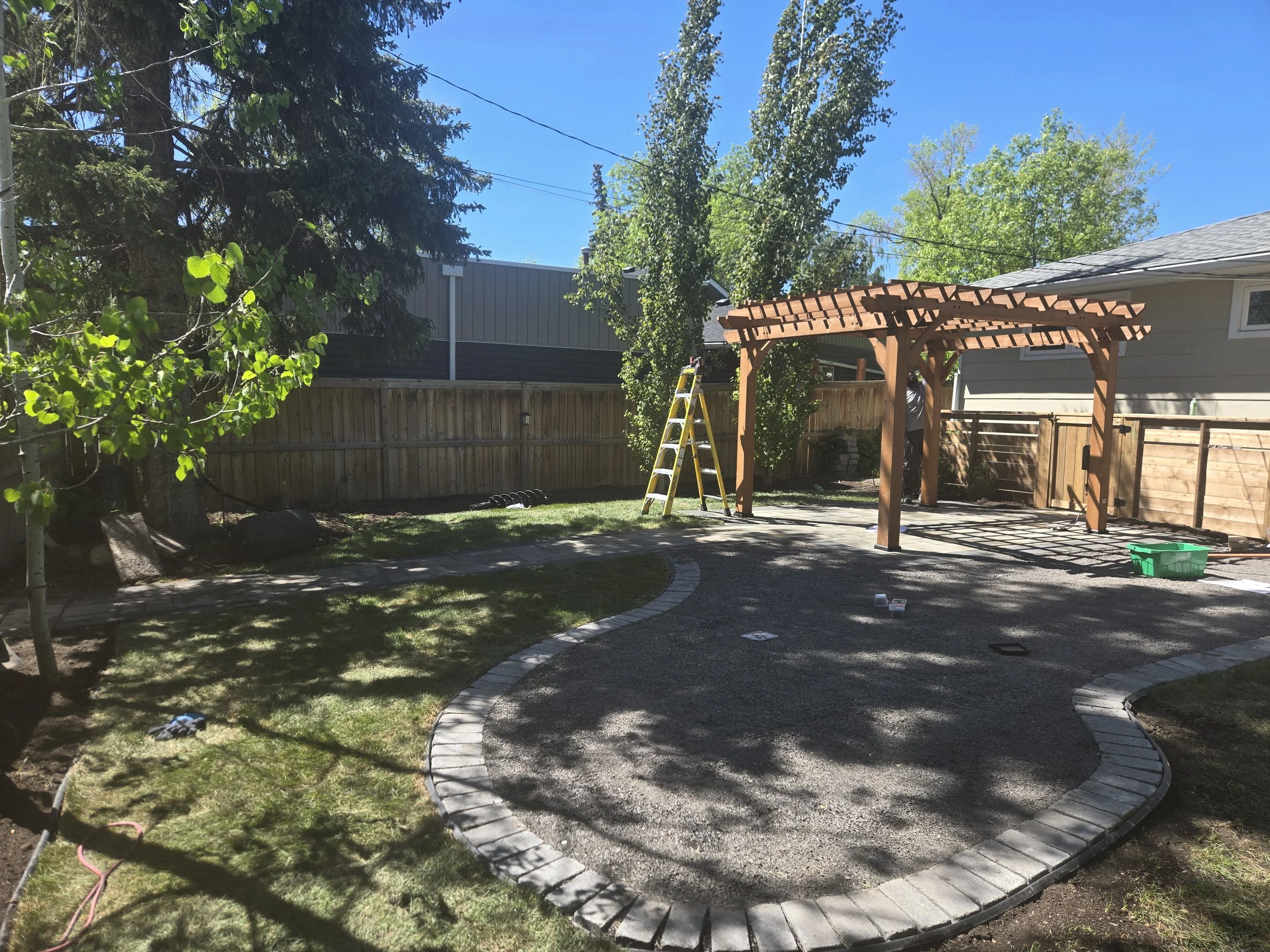 backyard with a pergola and brick patio
