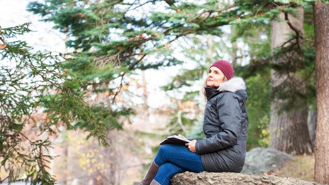 woman sitting in nature contemplating honesty as a core value blog
