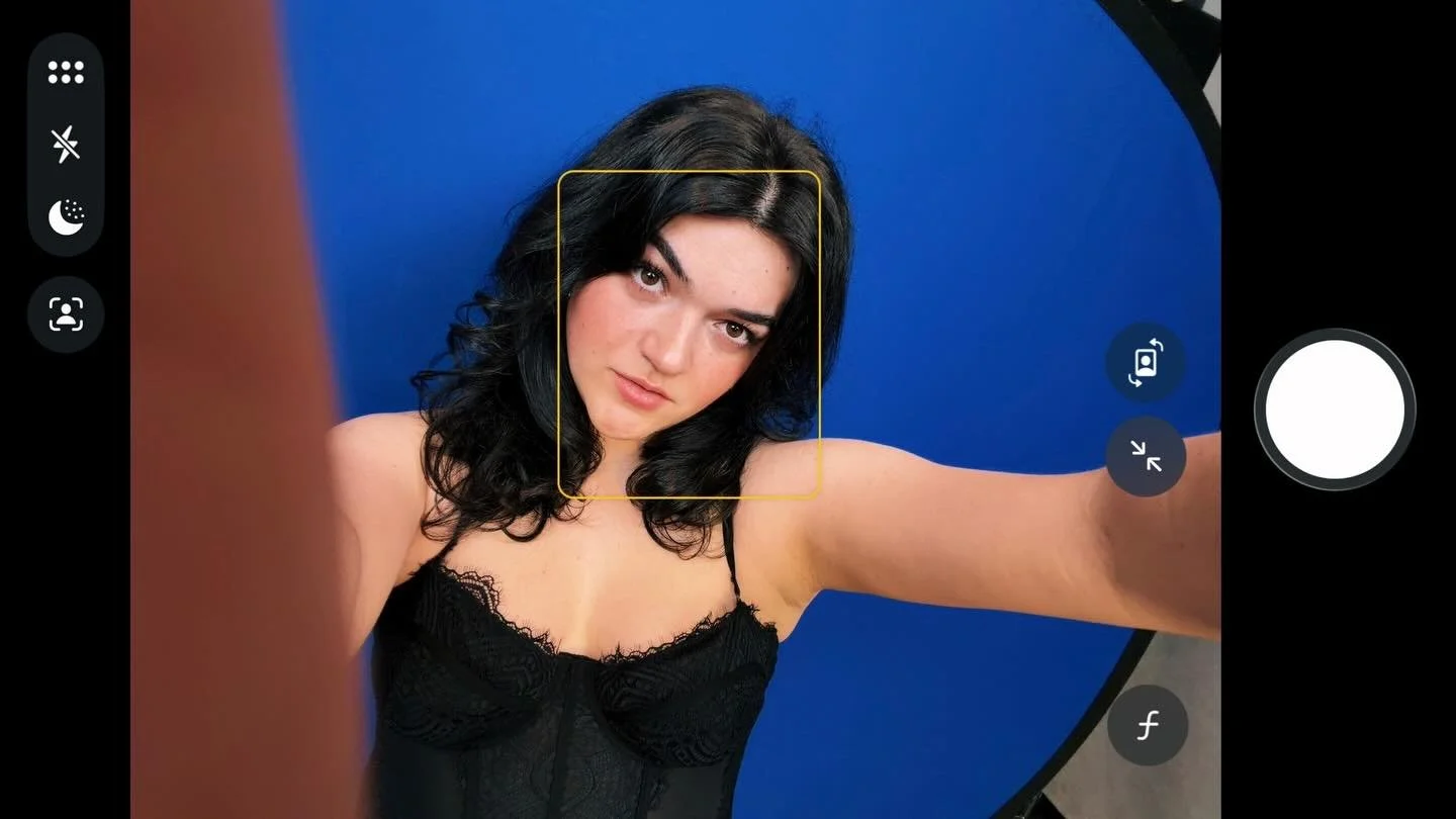 back in front of the blue backdrop