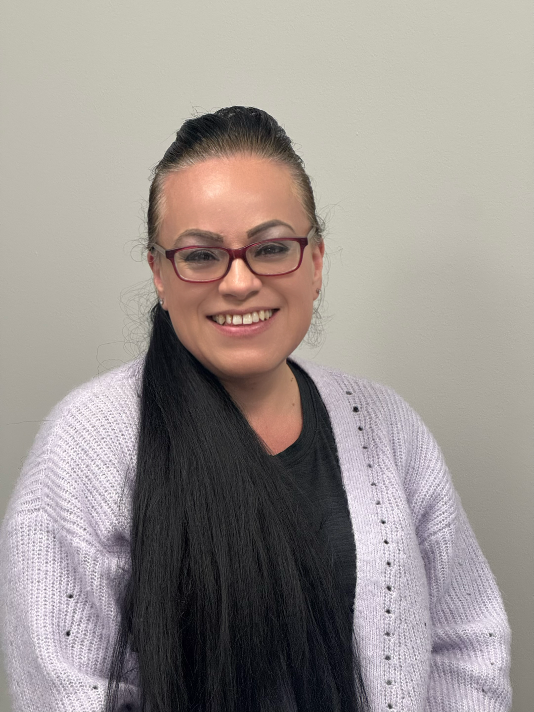 Childcare attendant with a warm smile and lavender sweater