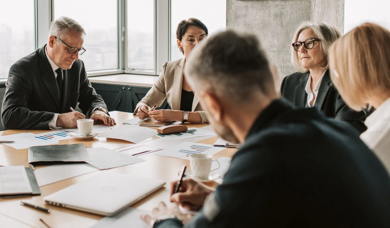Executive leadership team discussing growth strategy, capital allocation, and business investment decisions during a strategic planning meeting.