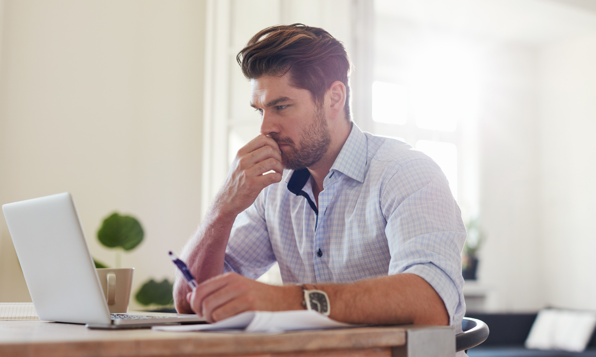 Professional reflecting at a laptop on workplace frustration, communication, and recurring career patterns.
