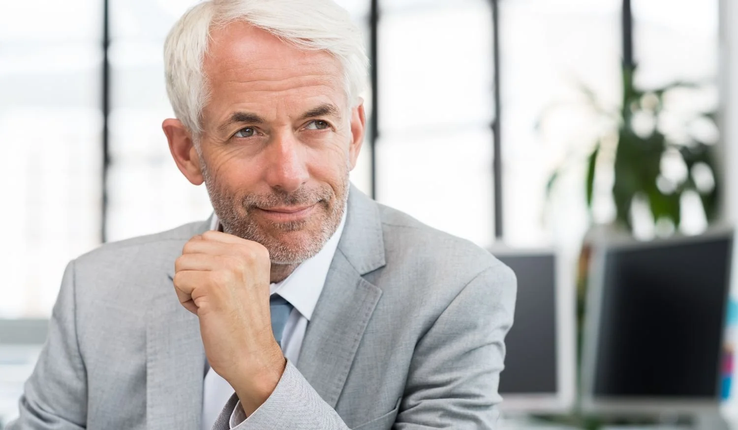 Executive leader thoughtfully evaluating a business decision, representing leadership readiness and internal promotion assessment.