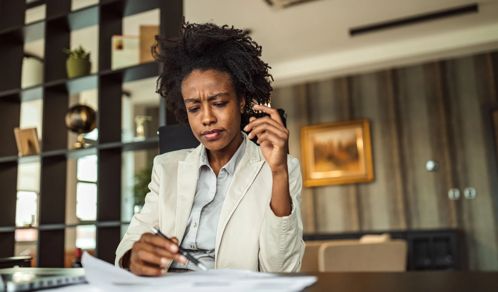 Professional reviewing documents during a hiring decision conversation, representing how qualified candidates are evaluated