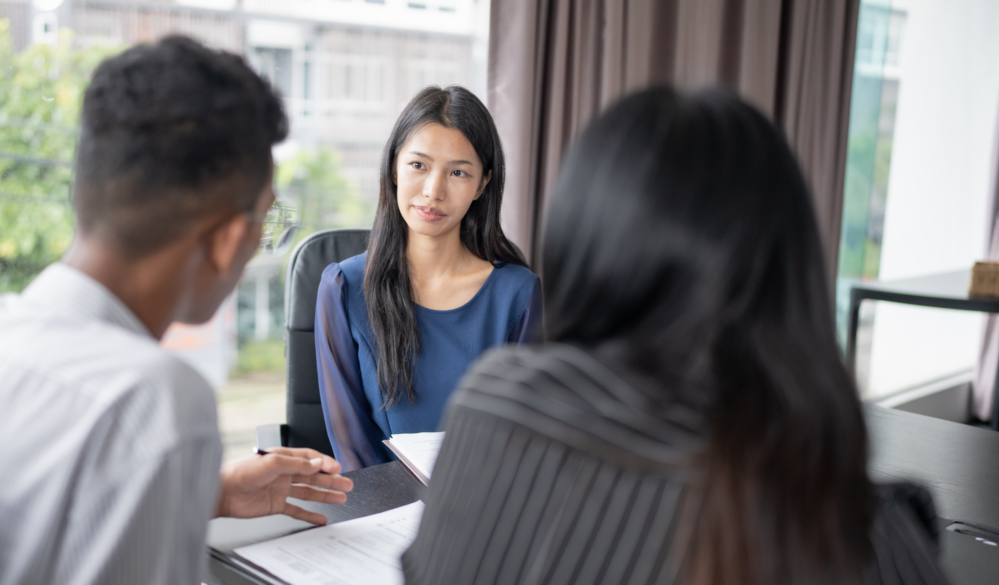 Hiring managers interviewing a candidate during a job interview conversation