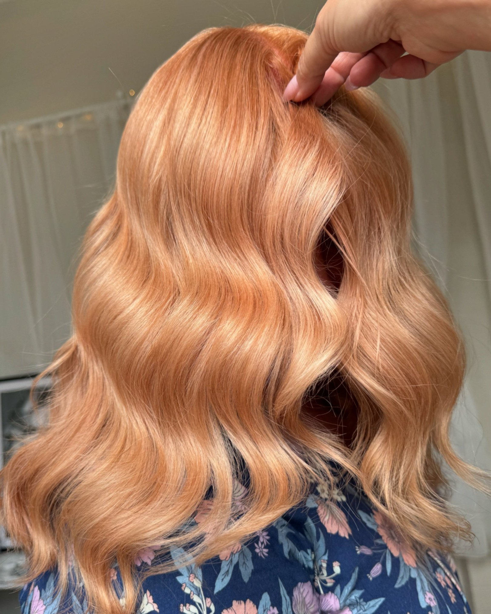Glossy copper red hair styled in soft waves by Sydney hairdresser Nikki Mahera
