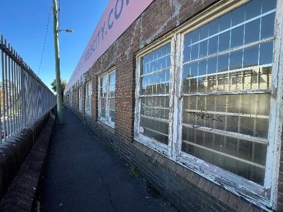Exterior of an older brick industrial building in Forest Lodge assessed during a pre-demolition hazardous materials survey.