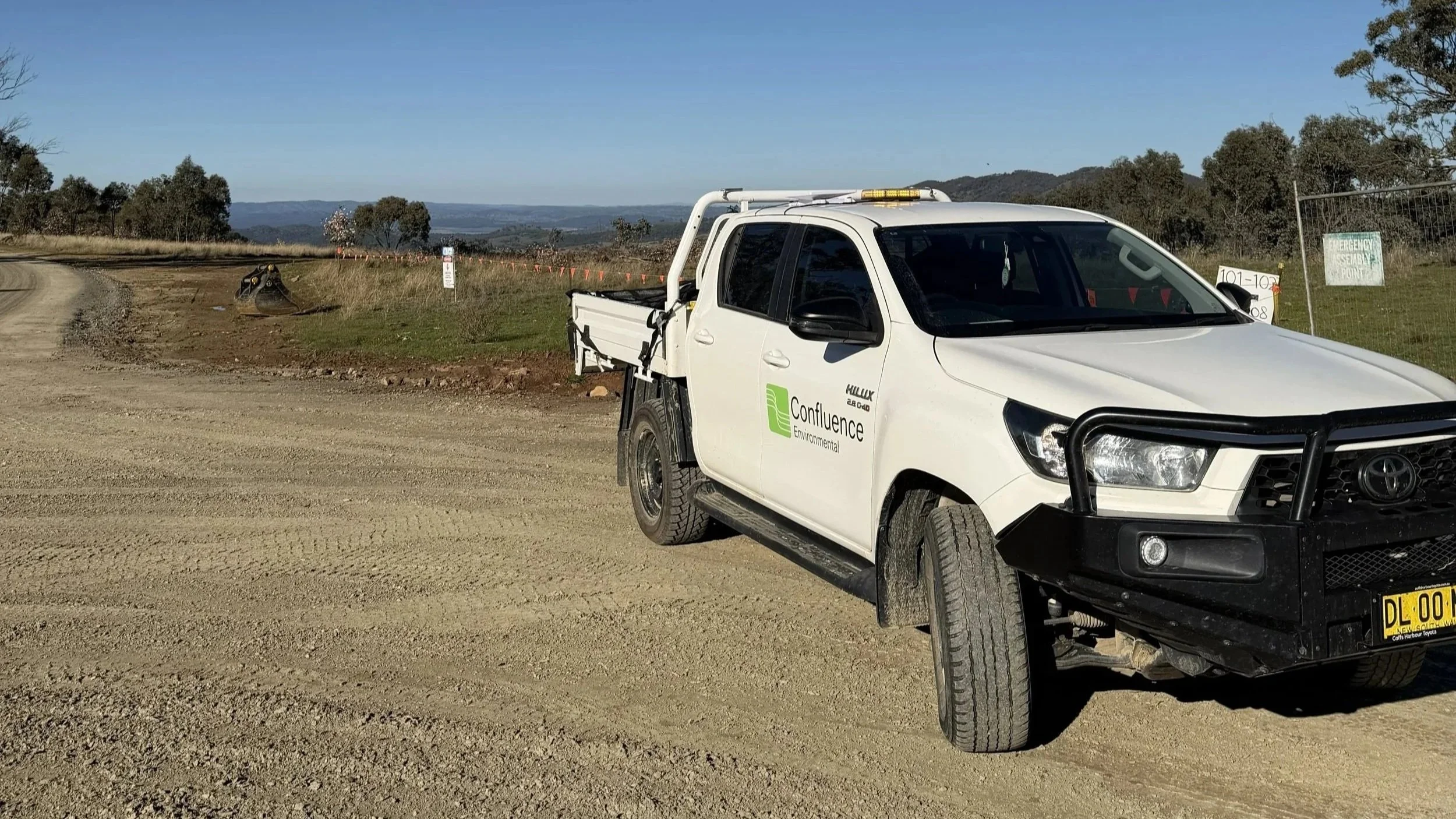 Confluence car parked with a view of the central tablelands during a detailed site investigation of the Uungula Wind Farm Project