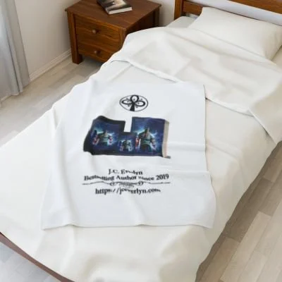 White bed with a blanket featuring a book cover, author, and website, in a bedroom with a wooden nightstand.
