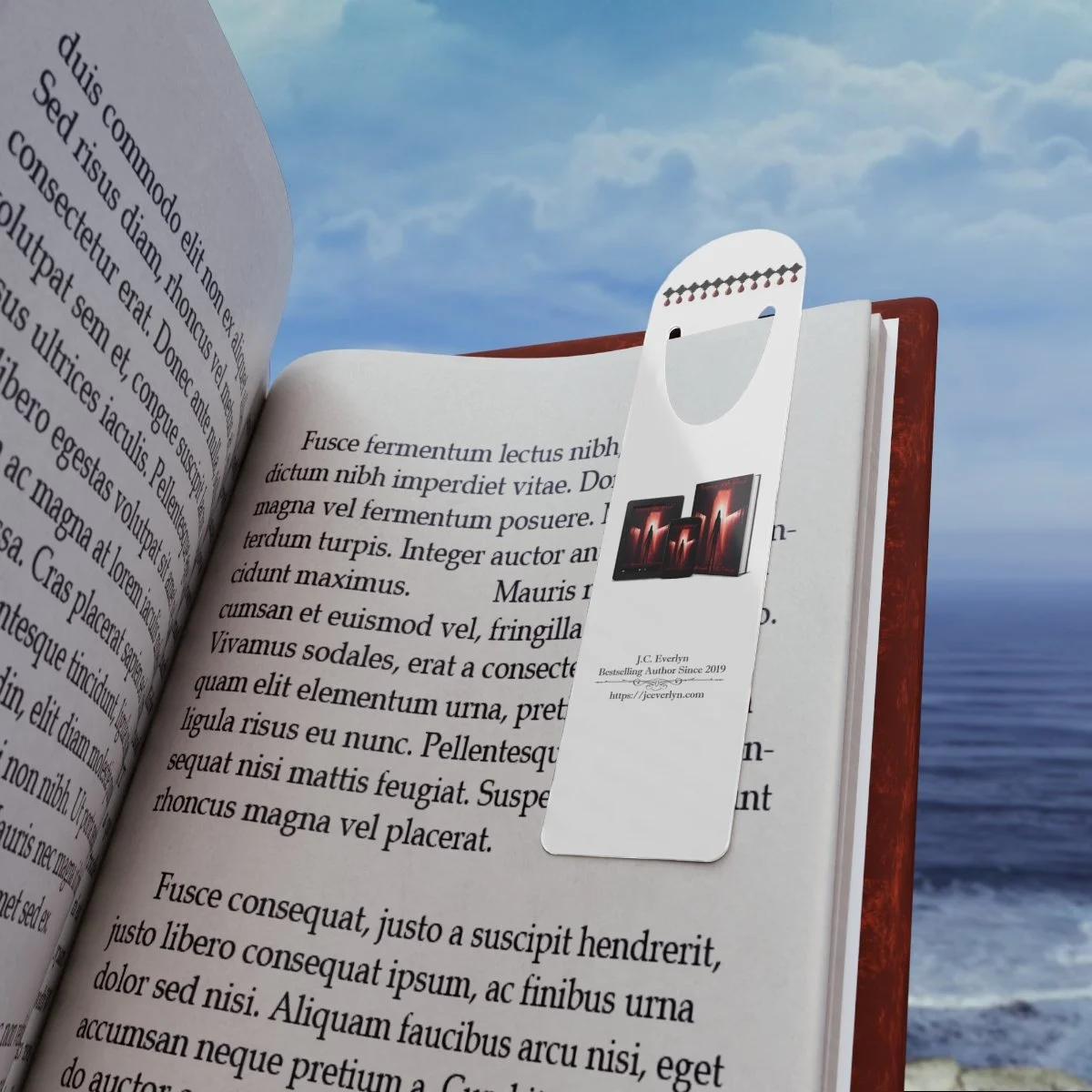 Open book with a bookmark tag featuring images of screens at the beach, against a background of ocean and sky.
