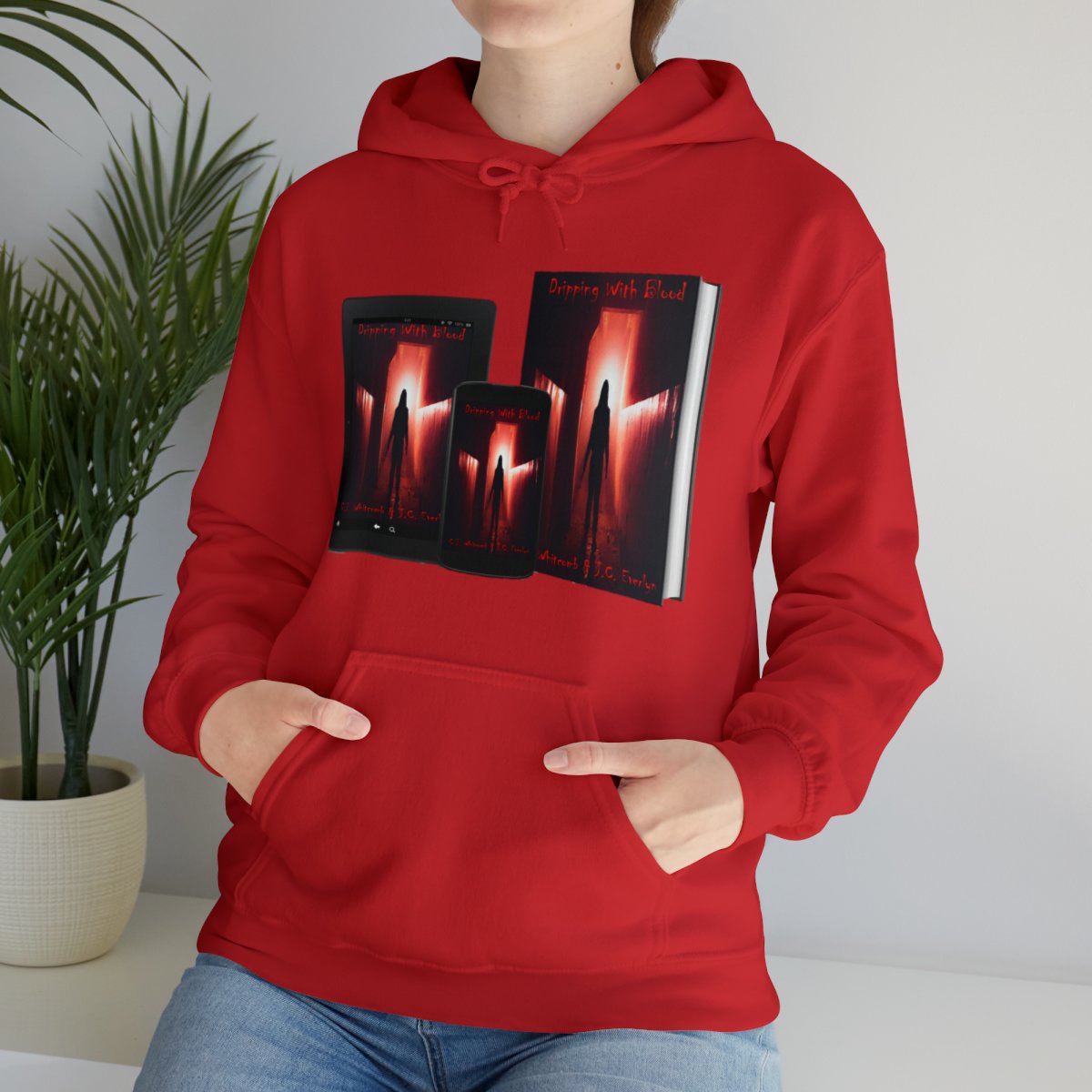 Person wearing a red hoodie with a graphic of a book cover titled "Dipping With Blood" featuring a silhouette of a person walking through flames.