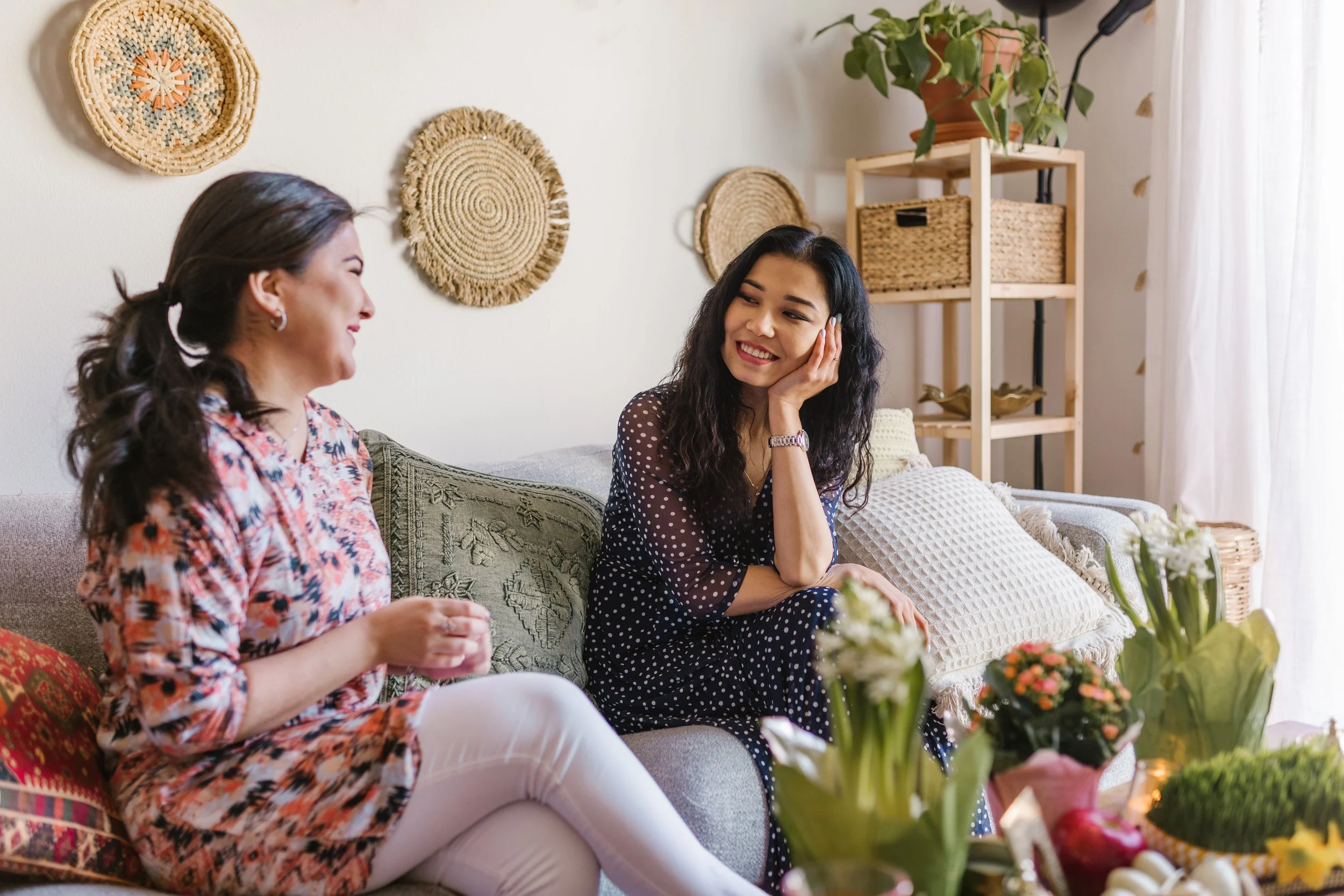 Two women in warm conversation, one listening attentively, representing the therapeutic support available for women navigating burnout and the mental load in Maryland, Virginia, and D.C.