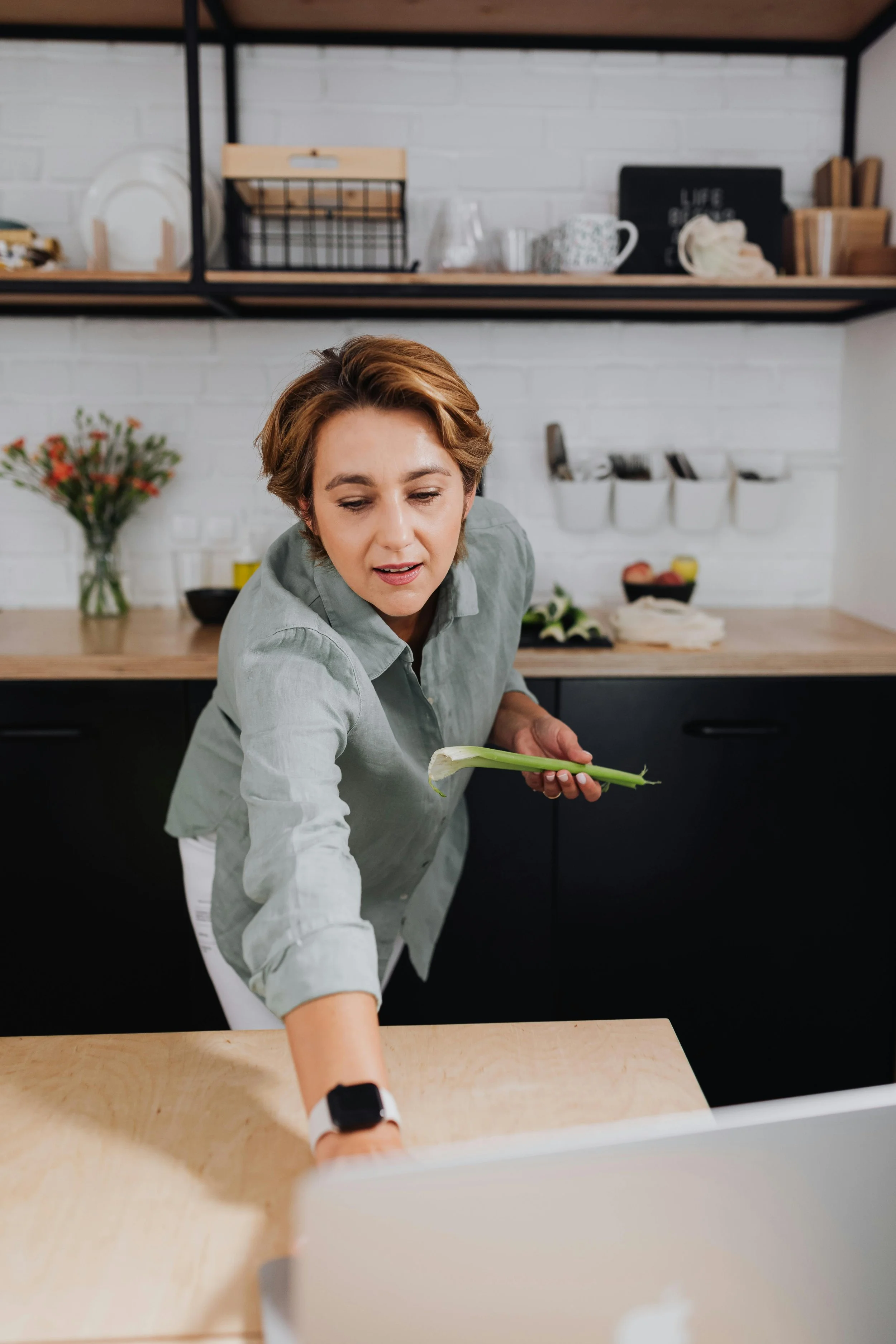 Woman multitasking in the kitchen, representing the over-functioning and chronic over-responsibility that boundaries therapy helps address