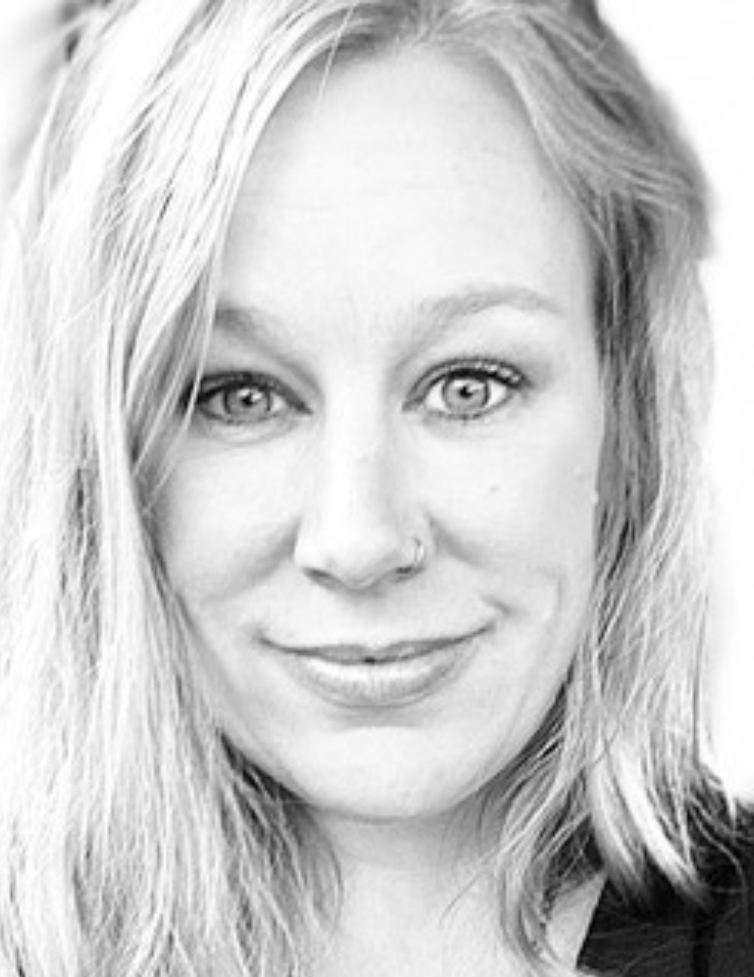 Black and white close-up portrait of a person with long hair.