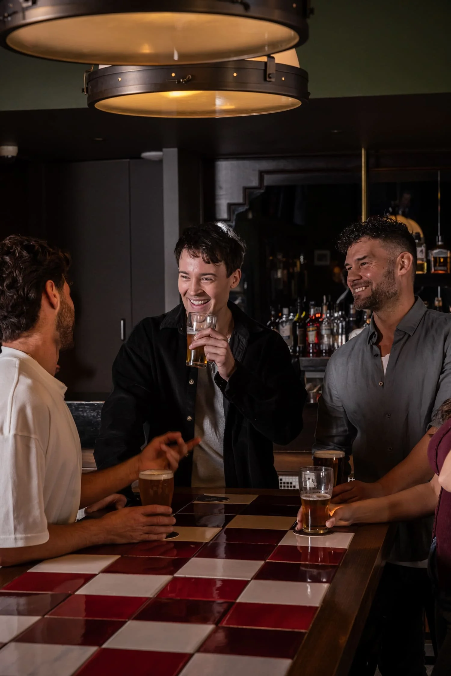 St Leonards Tav people laughing around a bar table
