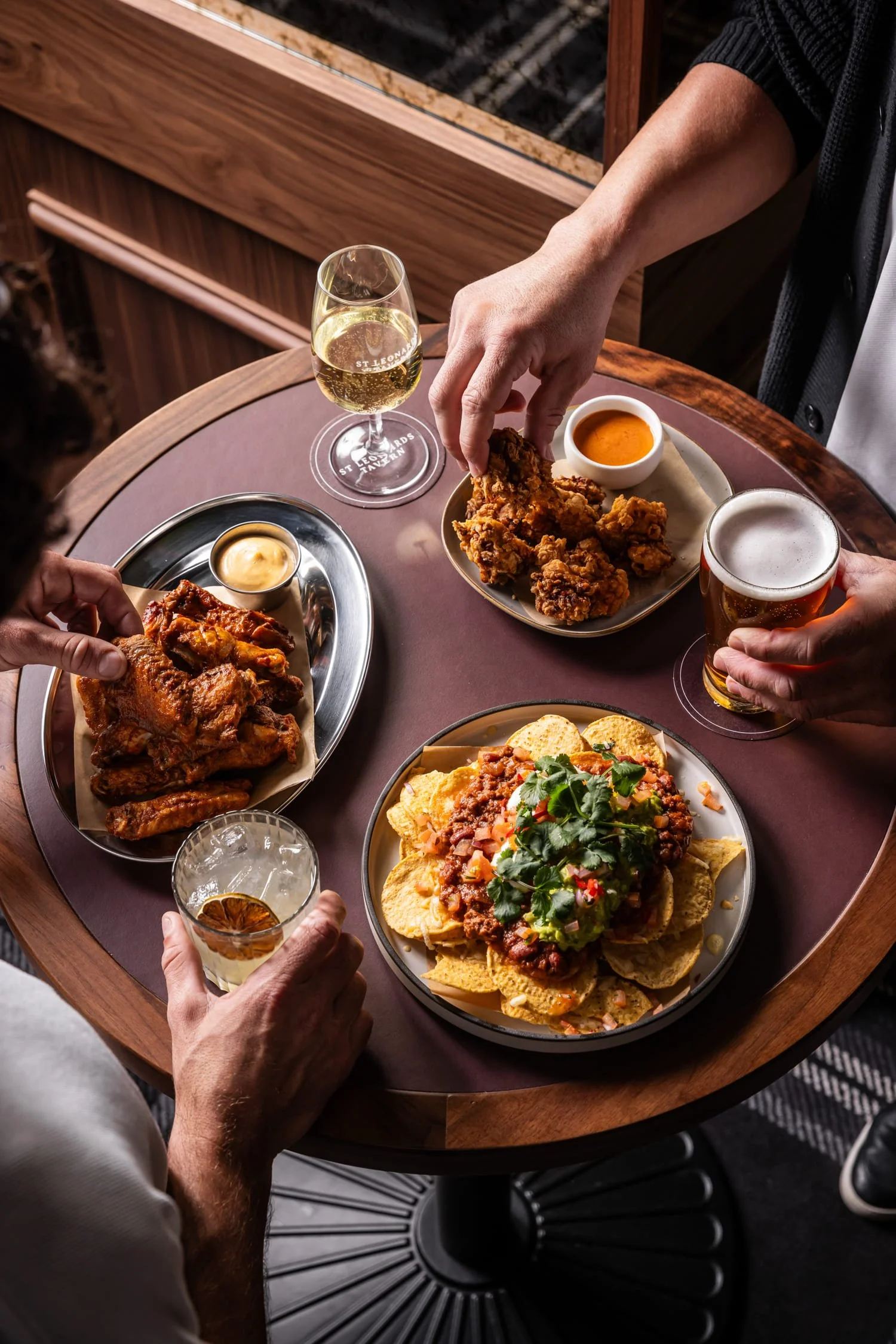 St Leonards Tav people eating nachos, chicken and drinking beer