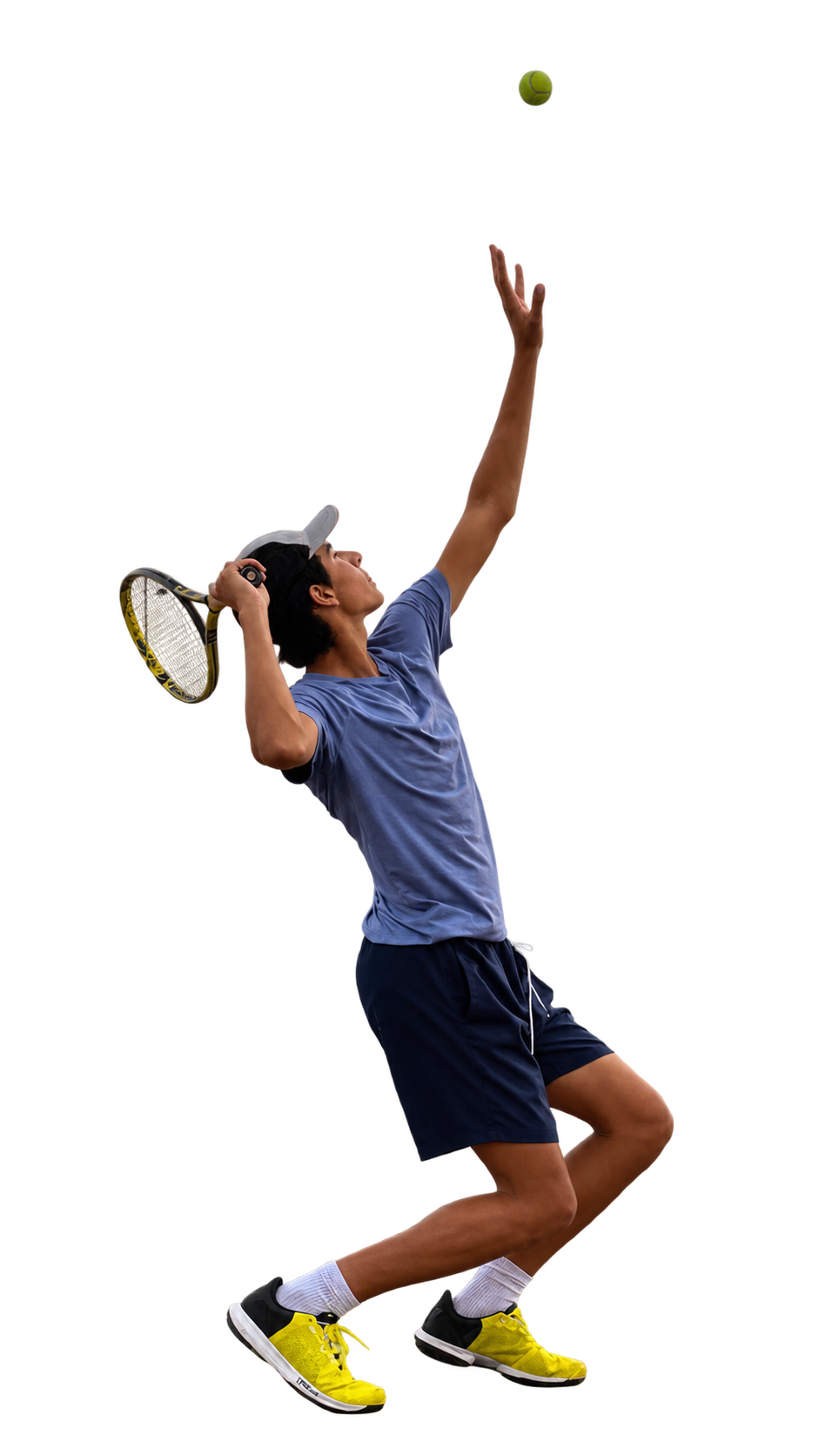 A young male tennis player in a blue shirt and black shorts practicing serves, with a tennis racket and ball in the air.