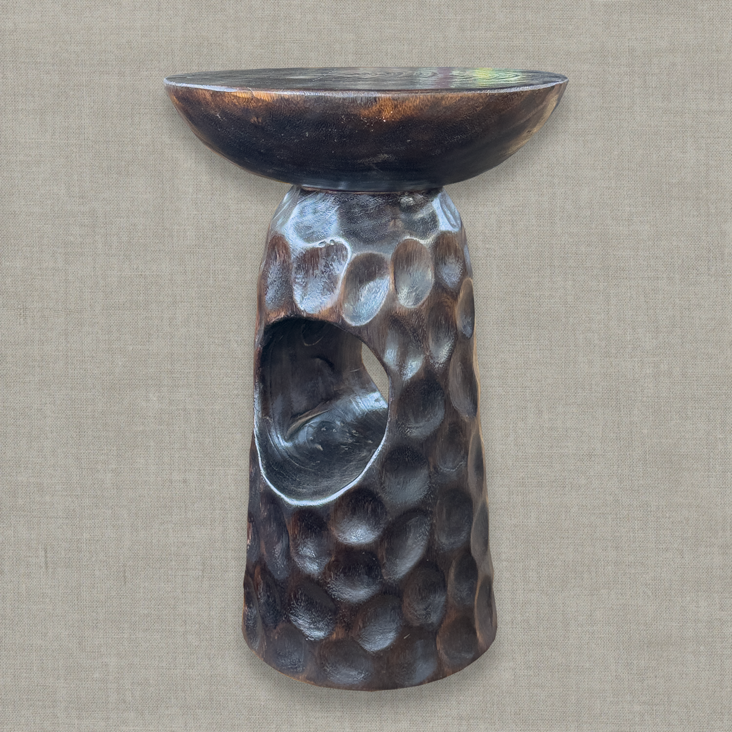 Hand carved solid mango wood sculptural pedestal table in glossy dark brown finish for a modern California living room