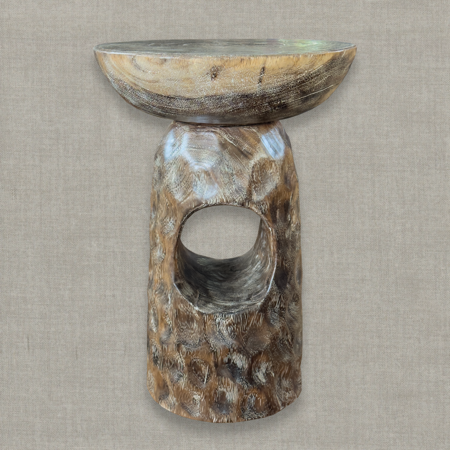 Hand carved solid mango wood sculptural pedestal table in glossy brown erosion finish for a modern California living room