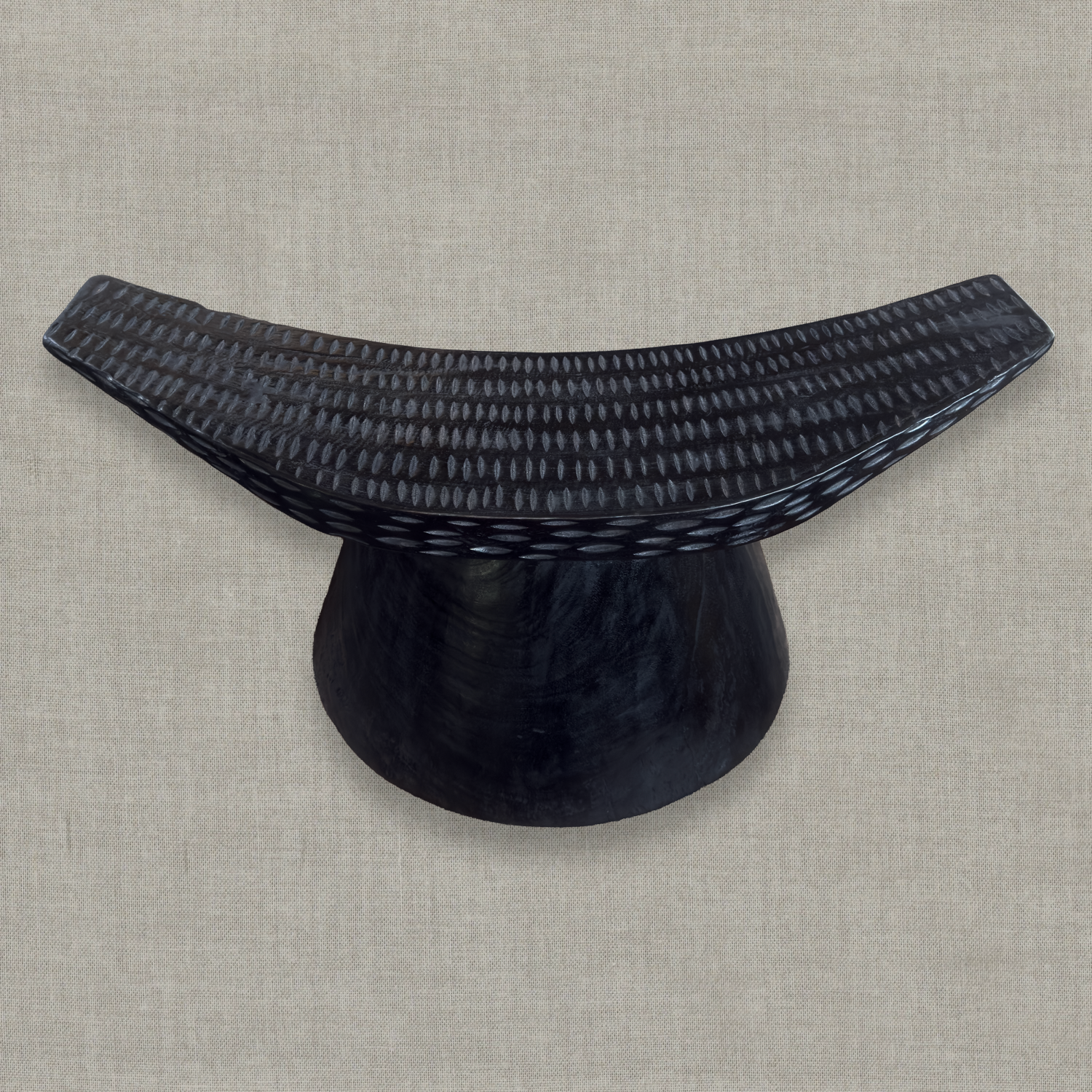 Sculptural mango wood bench with curved seat and carved details in matte black finish styled for modern interior in California