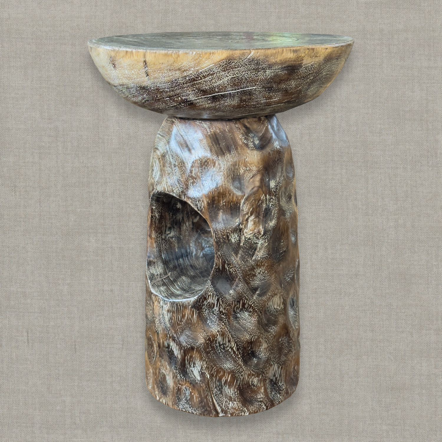 Hand carved solid mango wood sculptural pedestal table in glossy brown erosion finish for a modern California living room