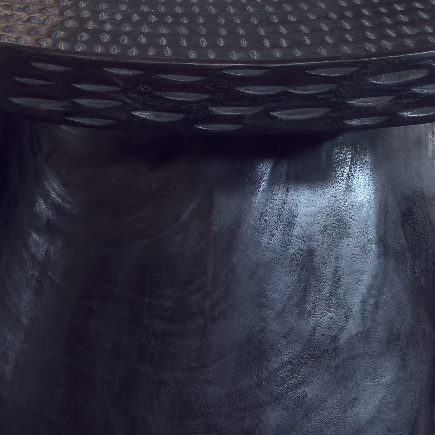 Sculptural mango wood bench with curved seat and carved details in matte black finish styled for modern interior in California