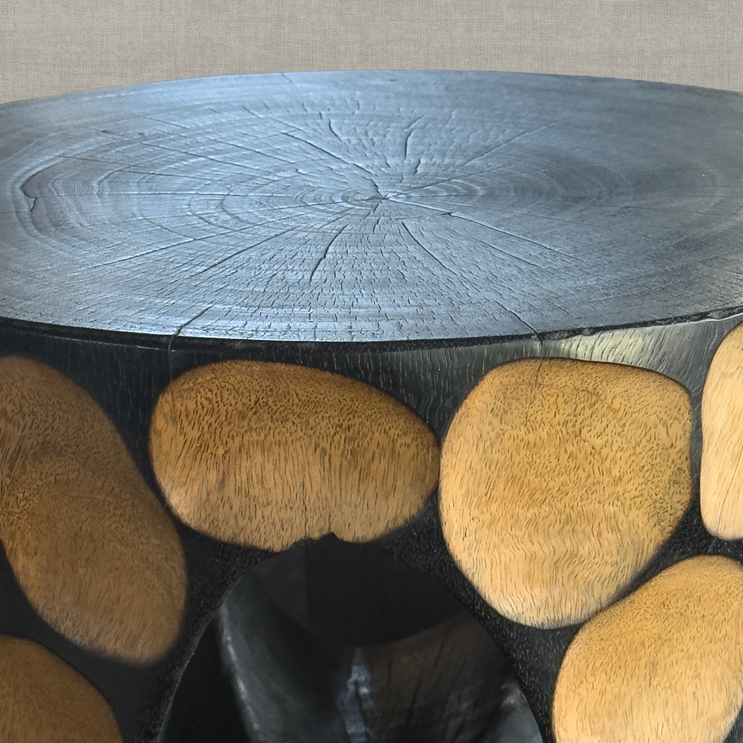 Hand carved solid mango wood sculptural pedestal table in glossy black finish for a modern California living room