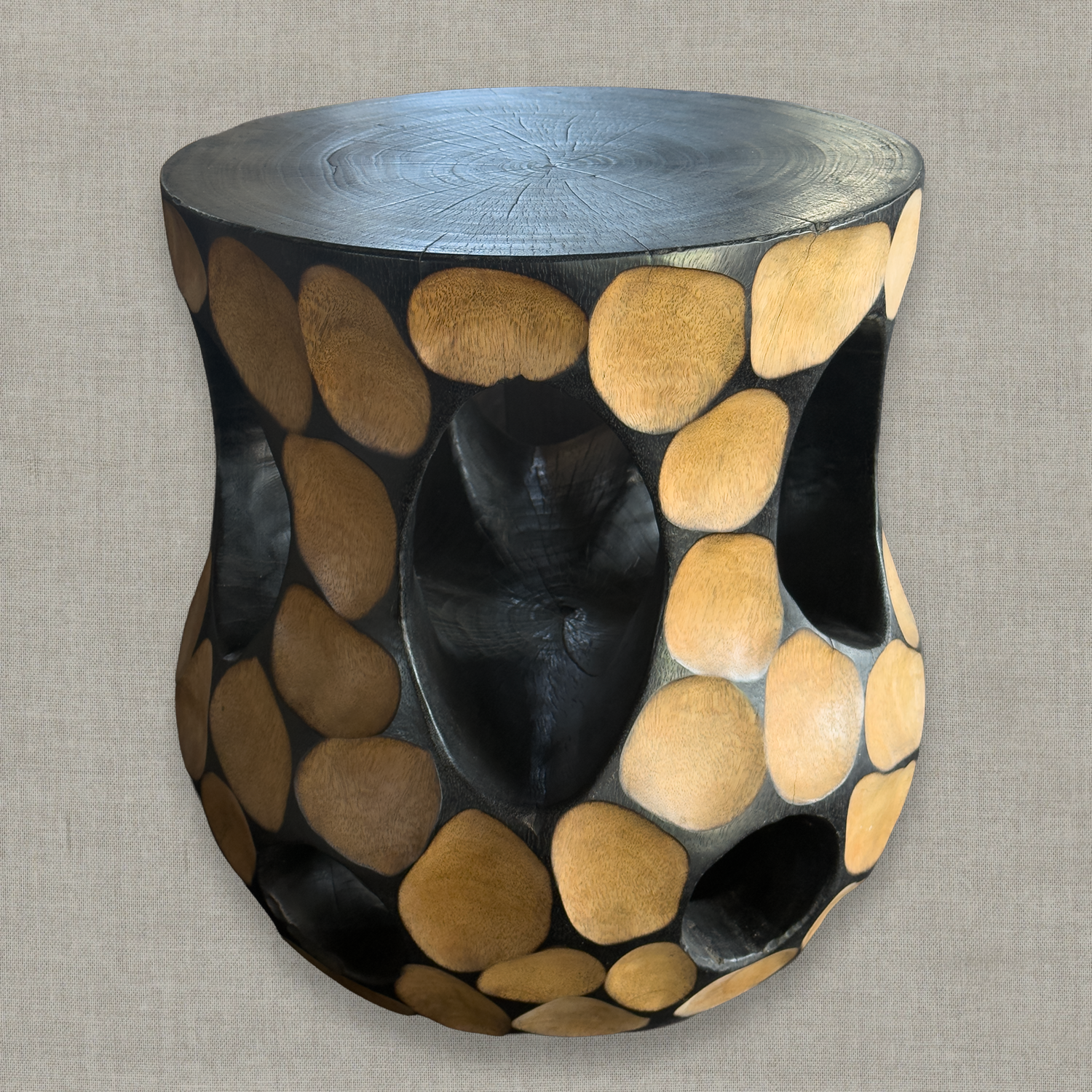 Hand carved solid mango wood sculptural pedestal table in glossy black finish for a modern California living room