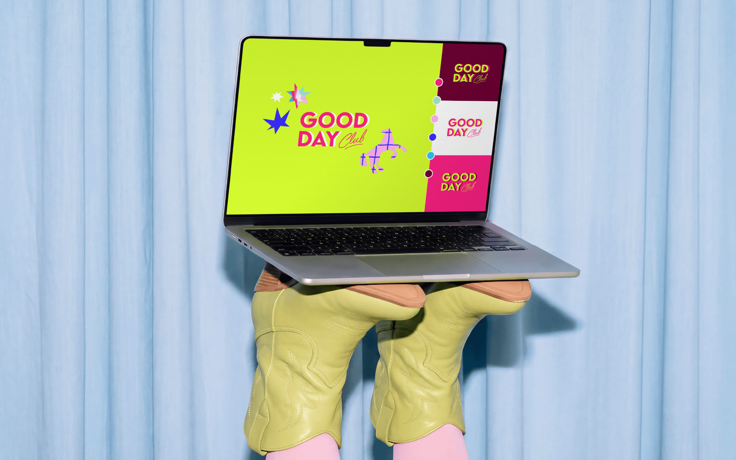 Brand board mockup for a commercial interior design studio, featuring logo variations and colour swatches on a laptop balanced on upturned lime green cowboy boots against a pale blue curtain.