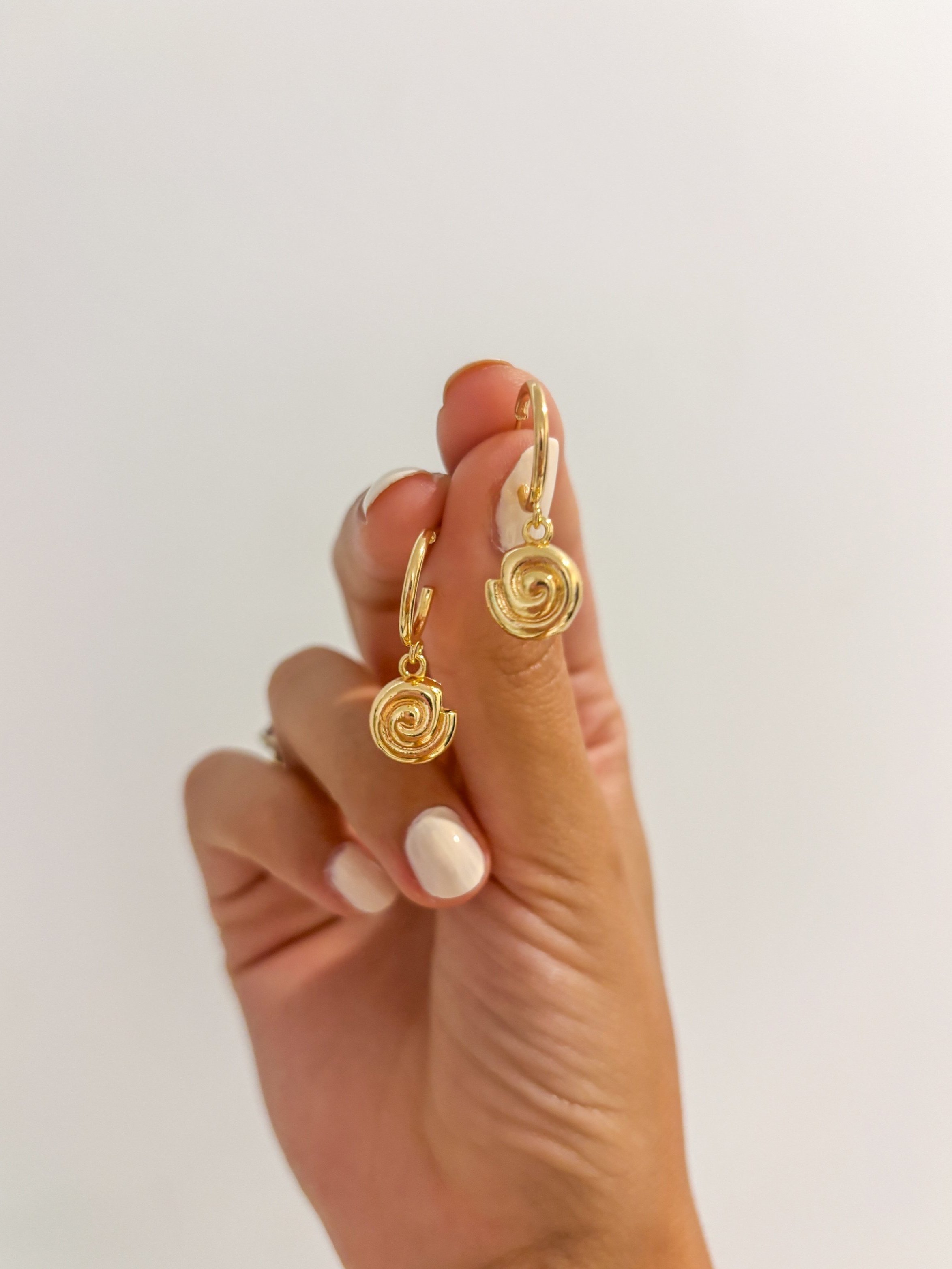 nautilus-shell-earrings-held-up.jpg