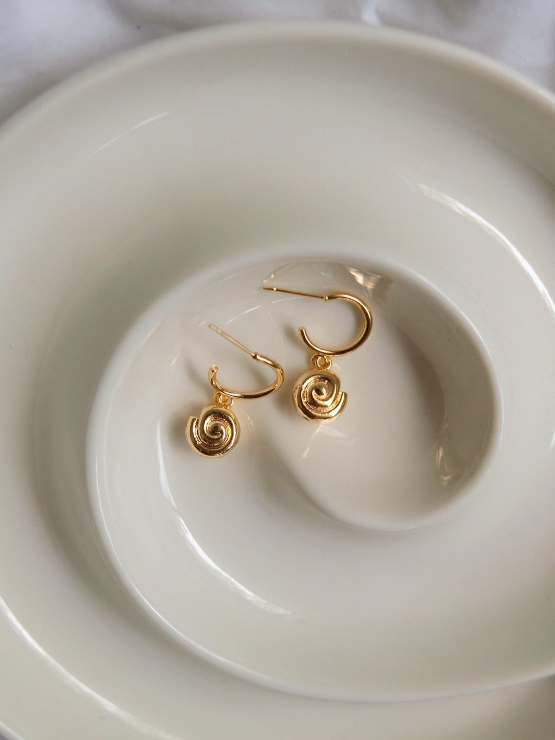 nautlus-earrings-flatlay.jpg