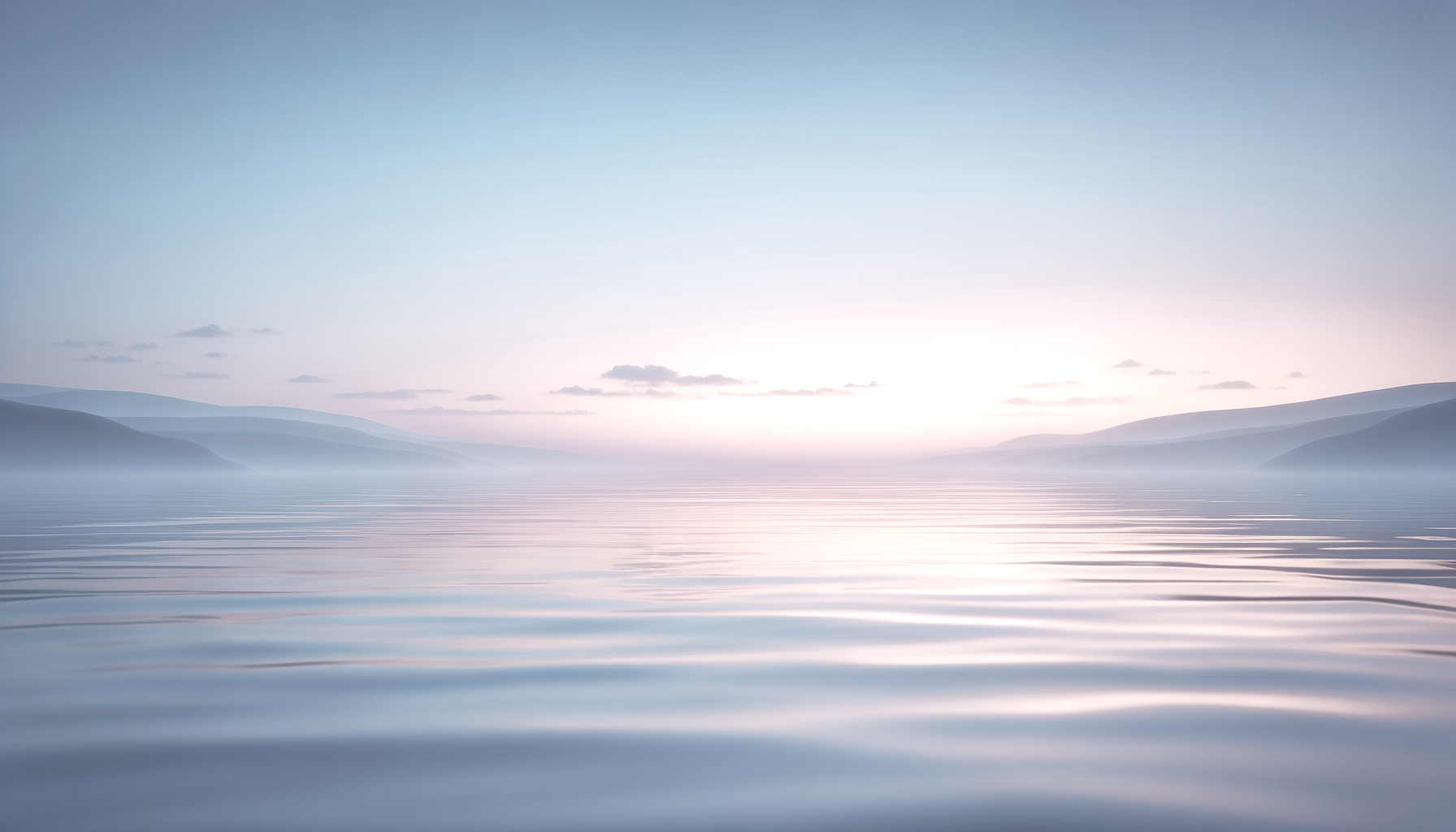 Calm body of water at sunrise with mountains in the distance and soft pastel sky.
