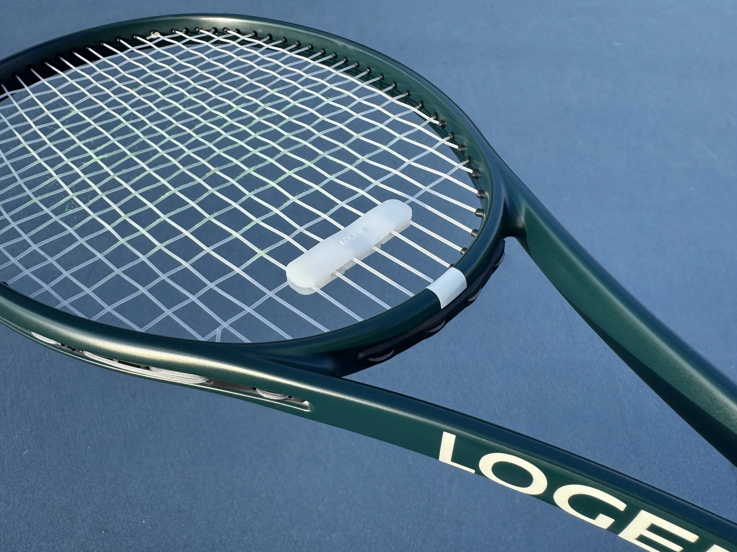 tennis racket dampener_on_racket_closeup-transparent.jpg