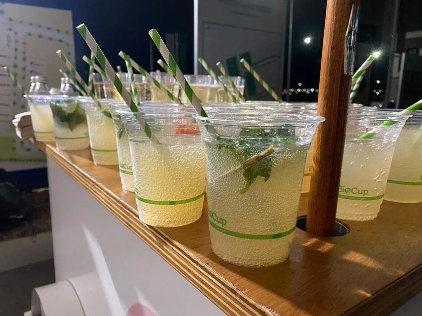 Refreshing drinks served in clear cups from a mobile wellness cart