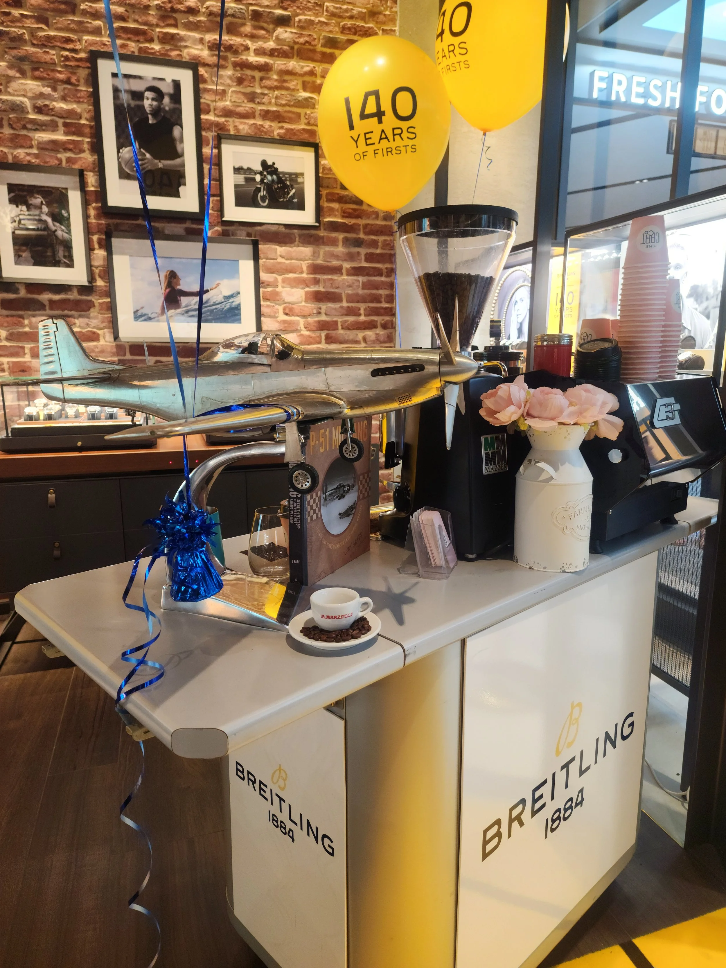 Branded espresso cart with aircraft display at an event