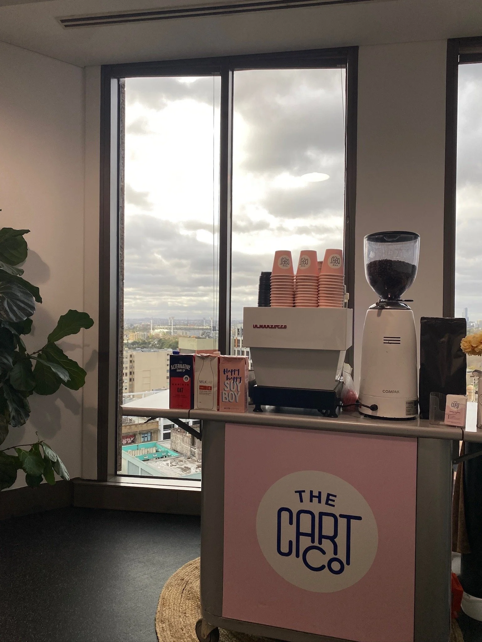 Mobile espresso coffee cart beside a window overlooking the Gold Coast