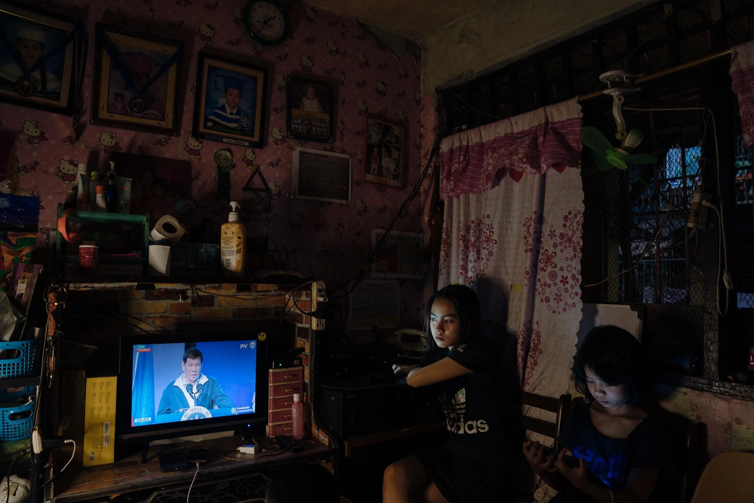 Students do their school work at home, as Duterte makes a speech on television.