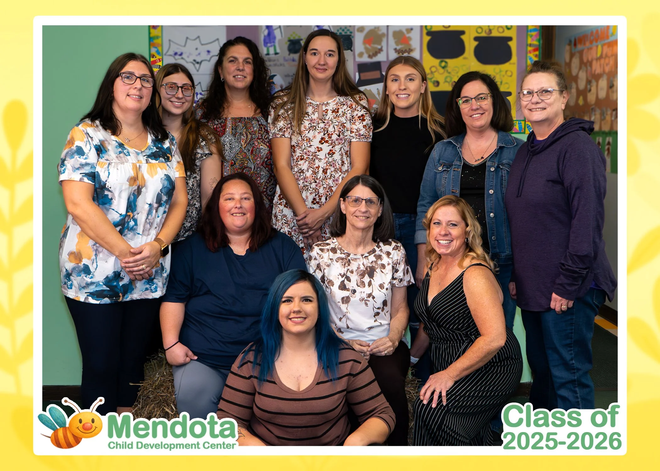 A class photo of all of the teachers, with the logo of the school at the bottom left, and text stating class of 2025-2026 on the bottom right