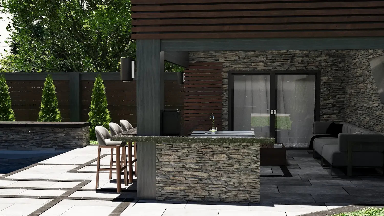 Outdoor patio with stone and wood accents, barstools at a stone kitchen island, patio furniture on a tiled floor, and a sliding glass door leading inside, surrounded by greenery.