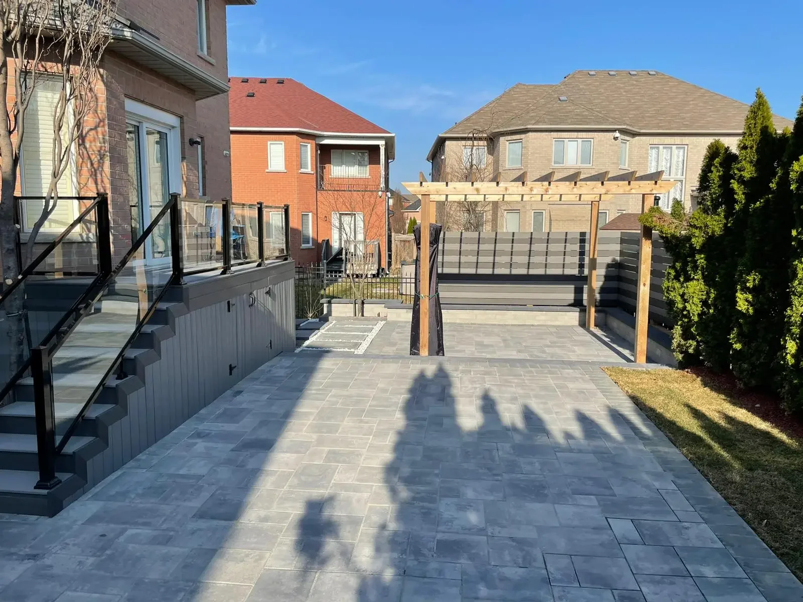 small backyard interlocking patio cost Toronto drainage edge
