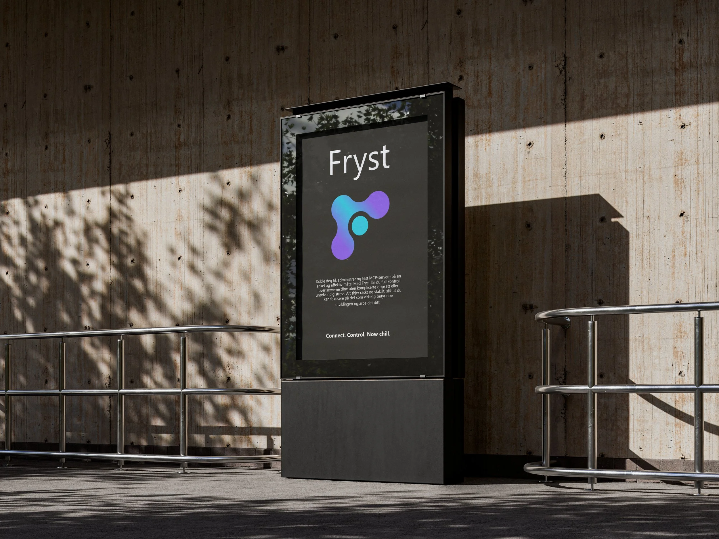 A corridor with a concrete wall, metal railings, and a digital sign promoting the Fryst brand with a logo and some text.
