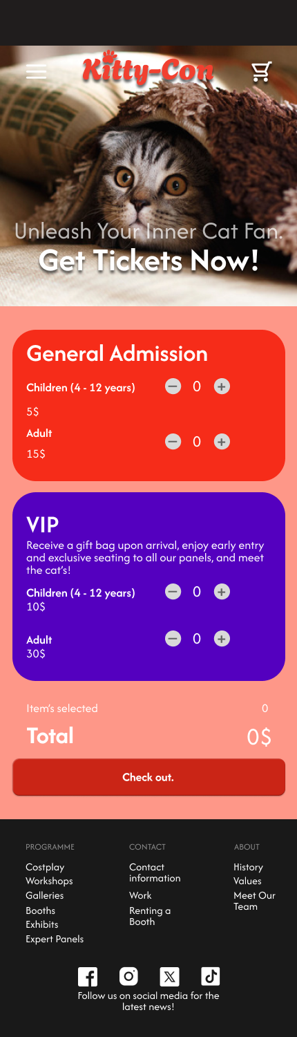 Close-up of a cute gray tabby cat with large eyes, partially covered by a blanket or cloth, on a cozy bed or surface, with a pillow in the background.