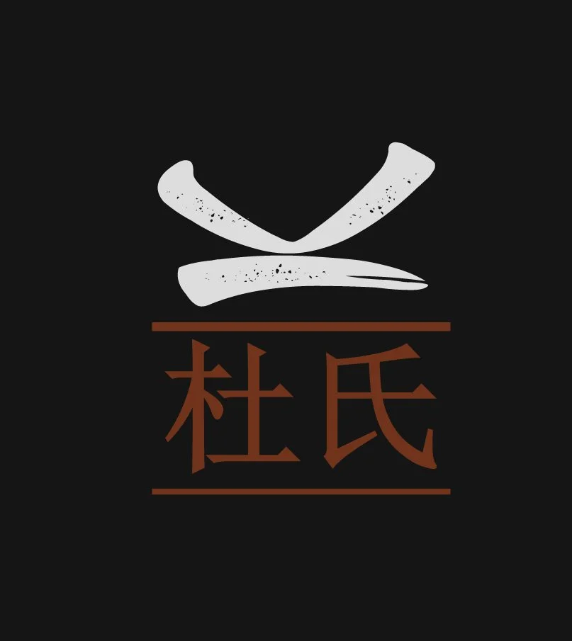 Stylized graphic with Japanese characters and a minimalist depiction of a hat or headwear. The background is black with white and brown elements.
