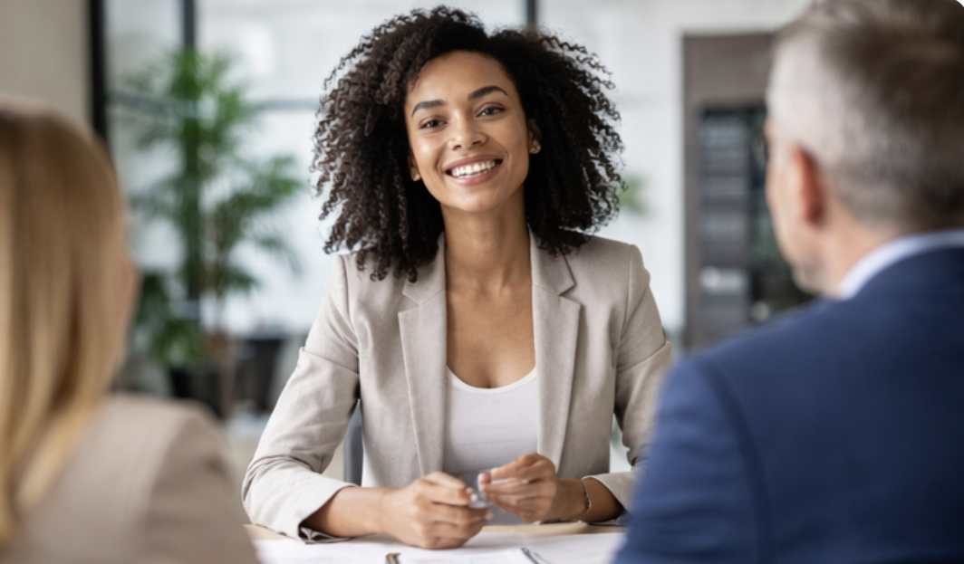 Woman with curl hair smiling during an interview