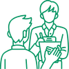Green line illustration of two people in an interview or evaluation setting, with one person holding a clipboard while speaking to another seated or standing opposite them, representing candidate assessment, sales coaching, or recruiter review.