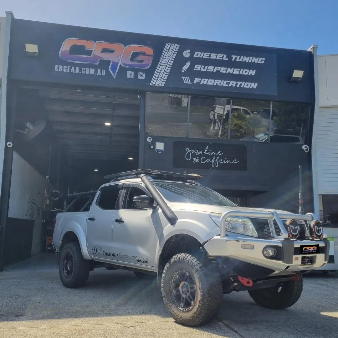 Custom off-road vehicle parked outside CRG garage